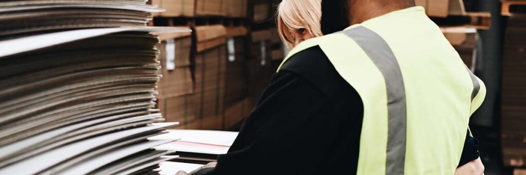 Person wearing high vis vest in factory