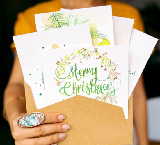 person-holding-selection-of-sustainable-Christmas-cards