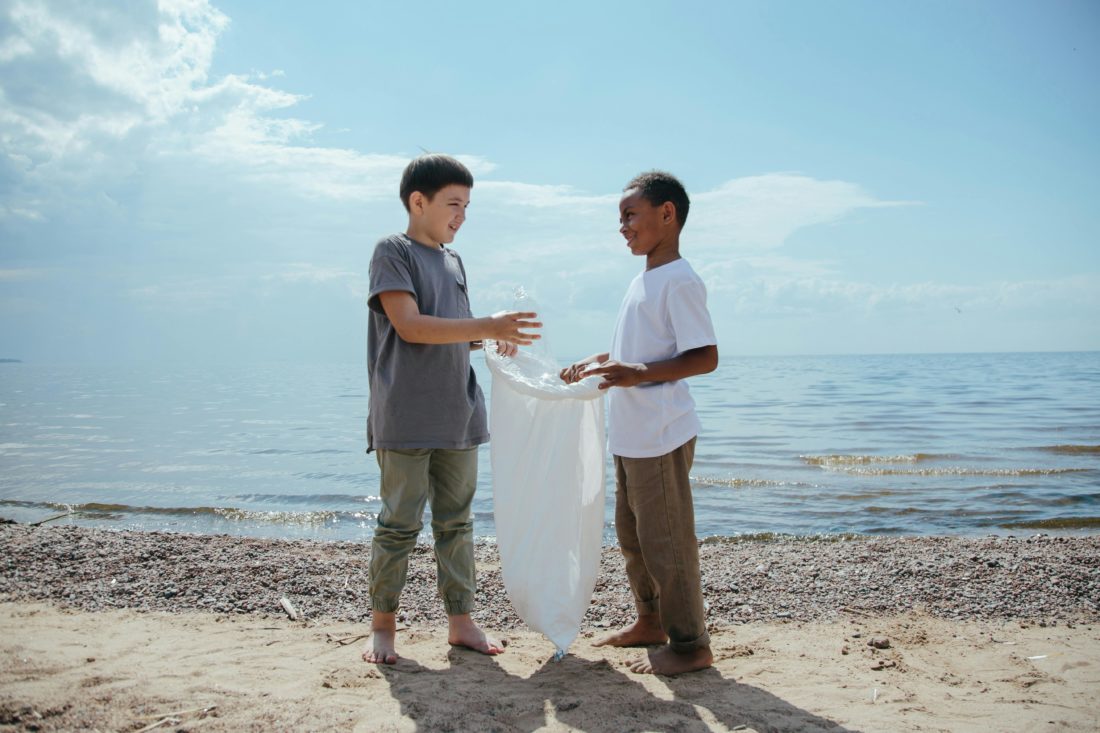 Boys-collecting-plastic-packaging-on-beach