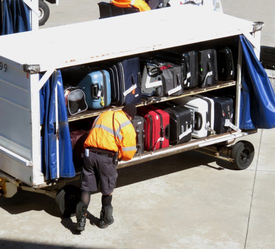 baggage-handler-with-case-in-containers