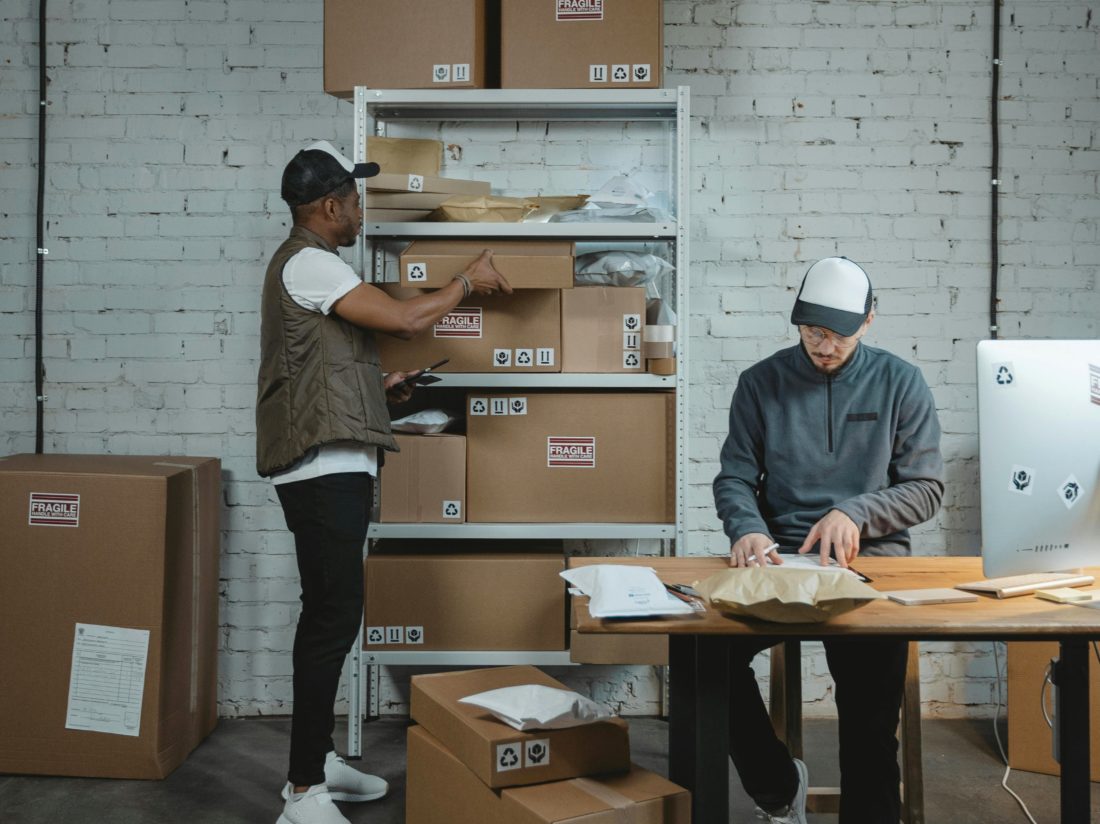 two men sorting deliveries and ecommerce returns