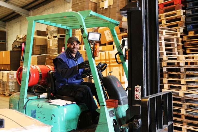 man-driving-forklift-in-packaging-factory